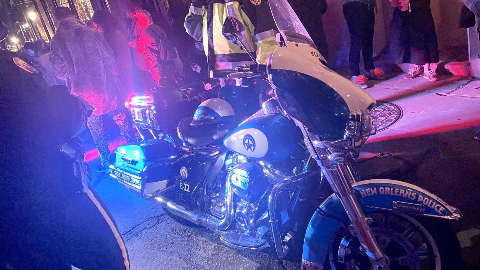 NOPD motorcycle caught fire in a Nola parade. The crowd took action — with cocktails.